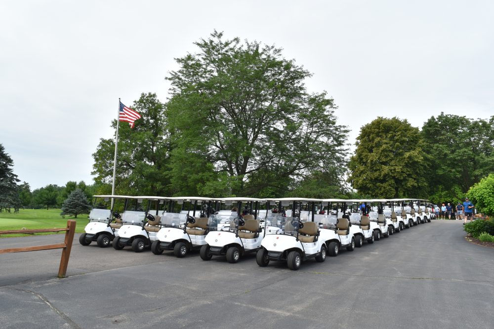 Golf carts lined up for start of golf outing