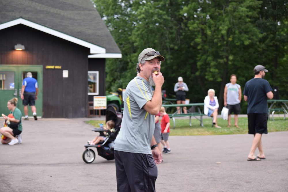 Participant of donut dash finishing a donut